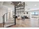 Open-plan living room with spiral staircase, hardwood floors, and seamless flow to the rest of the home at 3131 E Alameda Ave # 1107, Denver, CO 80209