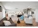 Bright, open-plan living room features hardwood floors, spiral staircase, and seamless flow to the kitchen at 3131 E Alameda Ave # 1107, Denver, CO 80209