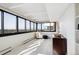 Bright sunroom with tile floors, large windows, and views of the city skyline at 3131 E Alameda Ave # 1107, Denver, CO 80209