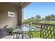 Relaxing balcony with outdoor seating and table overlooking a tranquil green space at 7462 S Quail Cir # 426, Littleton, CO 80127