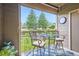 Cozy balcony featuring comfortable seating, a glass table, and serene views of the outdoors at 7462 S Quail Cir # 426, Littleton, CO 80127