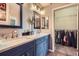 Bathroom with double sinks, walk in closet, and well-lit mirrors at 7462 S Quail Cir # 426, Littleton, CO 80127