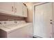 Laundry room with a white washing machine and a door at 7462 S Quail Cir # 426, Littleton, CO 80127