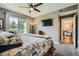 Relaxing bedroom boasts a ceiling fan, carpet floor, and a large window at 7462 S Quail Cir # 426, Littleton, CO 80127