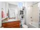 Bathroom featuring a granite vanity top, framed mirror, and tiled shower at 1106 Oak Cir, Lakewood, CO 80215