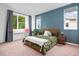 Comfortable bedroom with an accent wall, large windows, and a cozy window seat at 1106 Oak Cir, Lakewood, CO 80215