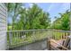 Relaxing deck with a view overlooking lush greenery and trees at 1106 Oak Cir, Lakewood, CO 80215