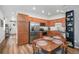 Eat-in kitchen featuring wood cabinetry, stainless steel appliances, and hardwood flooring at 1106 Oak Cir, Lakewood, CO 80215