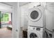 Laundry room with stacked washer and dryer, and storage shelves at 1106 Oak Cir, Lakewood, CO 80215