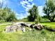 Picturesque creek with a quaint bridge, surrounded by lush greenery and striking rock formations at 1106 Oak Cir, Lakewood, CO 80215
