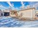 Home exterior features a carport, covered porch, and a partially snow-covered yard at 6500 E 88Th Ave # 258, Henderson, CO 80640