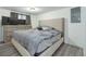 Bedroom featuring laminate flooring, a grey comforter, and a window with curtain at 6500 E 88Th Ave # 258, Henderson, CO 80640