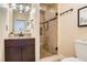 Bathroom features vanity, granite countertop, tiled shower with glass door, and modern fixtures at 3047 Osceola St, Denver, CO 80212