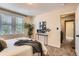 Bedroom with large window, carpet, and stylish plant accent at 3047 Osceola St, Denver, CO 80212