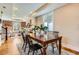 Open concept dining area with hardwood floors, adjacent to a living room and a large window that provides plenty of natural light at 3047 Osceola St, Denver, CO 80212