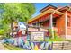 Bright bistro exterior with colorful mural, charming outdoor seating, and coffee signage at 3047 Osceola St, Denver, CO 80212