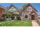 A charming home featuring a well-maintained lawn and inviting curb appeal near another home on the street at 3047 Osceola St, Denver, CO 80212