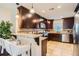 Modern kitchen features granite countertops, tile backsplash, stainless appliances, and dark wood cabinetry at 3047 Osceola St, Denver, CO 80212
