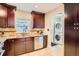 Well-appointed kitchen with stainless steel dishwasher, granite countertops, and direct access to laundry at 3047 Osceola St, Denver, CO 80212