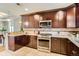 Kitchen boasting stainless steel oven, dark cabinetry, granite countertops, and decorative tile backsplash at 3047 Osceola St, Denver, CO 80212
