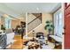 Bright and airy living room with hardwood floors, a staircase, and large windows providing ample natural light at 3047 Osceola St, Denver, CO 80212