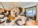 Inviting living room that offers a staircase, lots of natural light, and views into the adjacent dining area and kitchen at 3047 Osceola St, Denver, CO 80212