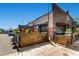 Exterior patio with metal planters, red umbrellas, and partial view of the building at 3047 Osceola St, Denver, CO 80212