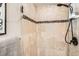 Close-up of the shower with stone tile and shower head at 3047 Osceola St, Denver, CO 80212