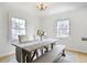 Bright dining room featuring hardwood floors, large windows, and a rustic table at 1601 Leyden St, Denver, CO 80220