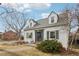 Quaint white brick home with gray shutters and well-maintained landscaping at 1601 Leyden St, Denver, CO 80220