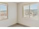 Bright bedroom with two windows offering city and mountain views at 12983 W Ida Ave # 301, Littleton, CO 80127