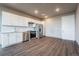 Modern kitchen with white cabinets and stainless steel appliances at 12983 W Ida Ave # 301, Littleton, CO 80127