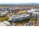 A lovely aerial view of the community surrounded by lush greenery and views of the city skyline at 2958 Syracuse St # 306, Denver, CO 80238