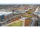 An aerial view shows a building across from a park and the surrounding community at 2958 Syracuse St # 306, Denver, CO 80238