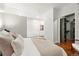 Bright bedroom featuring a walk-in closet with custom shelving and hardwood floors at 2958 Syracuse St # 306, Denver, CO 80238
