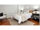 Cozy bedroom features a modern bed frame with neutral colored bedding and a patterned rug at 2958 Syracuse St # 306, Denver, CO 80238