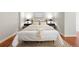 Cozy bedroom features a modern bed frame with neutral colored bedding, matching lamps, and patterned rug at 2958 Syracuse St # 306, Denver, CO 80238