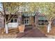 Welcoming building entrance with brick facade, glass awning, and landscaped surroundings at 2958 Syracuse St # 306, Denver, CO 80238