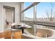 Bright dining area features a large picture window with neighborhood views and seating for two at 2958 Syracuse St # 306, Denver, CO 80238