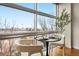 Bright dining area features a large picture window with neighborhood views and seating for two at 2958 Syracuse St # 306, Denver, CO 80238