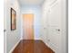 Hallway with wood floors and a view to a door at 2958 Syracuse St # 306, Denver, CO 80238