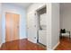 Bright hallway with wood floors, in-unit washer and dryer, and white walls at 2958 Syracuse St # 306, Denver, CO 80238