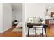 Hallway features a dark wood floor and stylish black desk, with a view to kitchen and bedroom at 2958 Syracuse St # 306, Denver, CO 80238