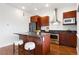 Bright kitchen features stainless steel appliances, dark granite counters, and wooden cabinets at 2958 Syracuse St # 306, Denver, CO 80238