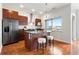 Modern kitchen with island, stainless steel appliances, and sleek cherry wood cabinetry at 2958 Syracuse St # 306, Denver, CO 80238