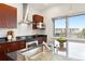 Bright kitchen features stainless steel appliances and hardware, granite counters, and wood cabinets at 2958 Syracuse St # 306, Denver, CO 80238