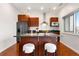 Modern kitchen with island, stainless steel appliances, and sleek cherry wood cabinetry at 2958 Syracuse St # 306, Denver, CO 80238