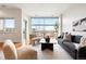 Bright living room featuring modern furnishings, large windows, and hardwood floors at 2958 Syracuse St # 306, Denver, CO 80238