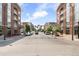 A street view shows a lovely view of the main street through the Primary-planned community at 2958 Syracuse St # 306, Denver, CO 80238