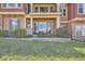 Backyard view shows the patio and outdoor seating area with lush greenery at 3181 Firenze Pl, Highlands Ranch, CO 80126